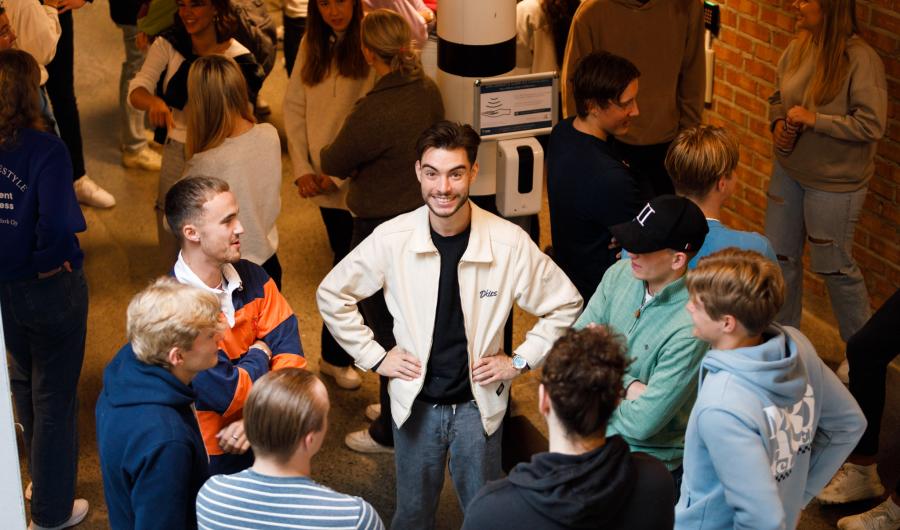 Studenter står samlet i en ring og prater sammen