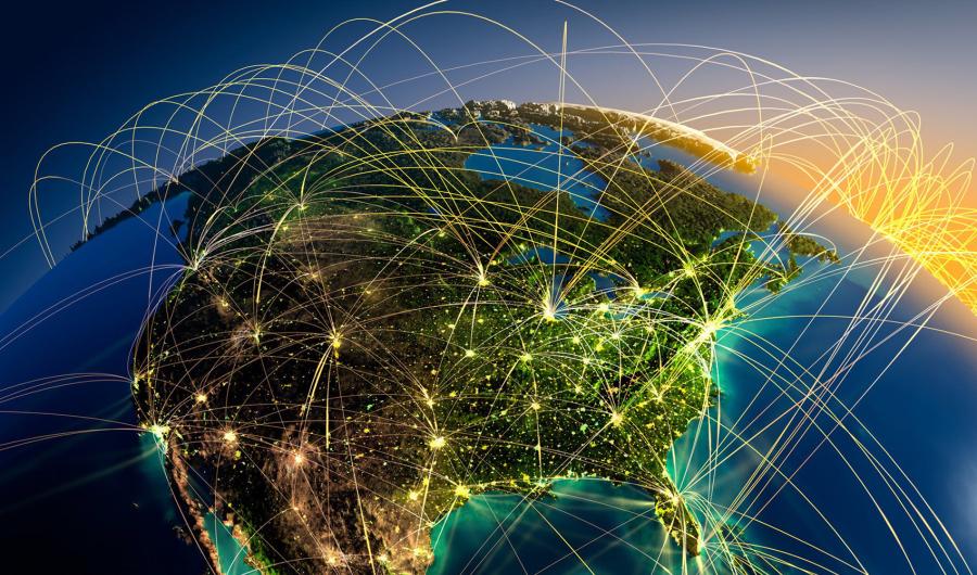 Jordklode med lysstråler som forbinder verdensdelene sammen