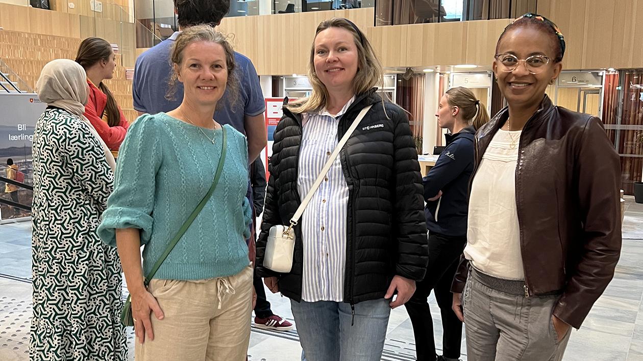 Three women in a shopping centre. Photo