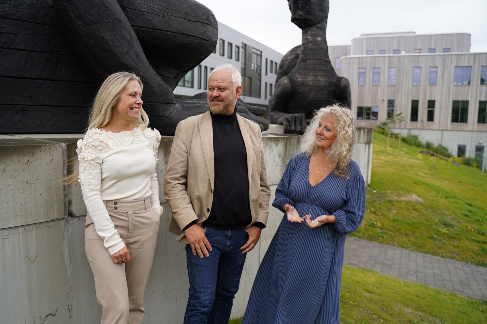 Forskningsformidlere foran skulpturene Universitetsportalen.